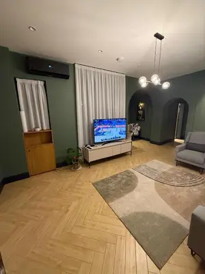 a living room with a flat screen tv and a couch at MiVa Apartment in Belgrade