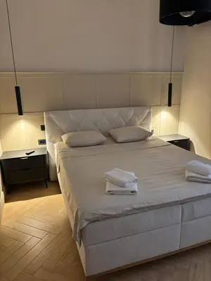 a bedroom with a large bed with two towels on it at MiVa Apartment in Belgrade