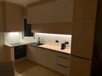 a kitchen with white cabinets and a sink and a stove at MiVa Apartment in Belgrade
