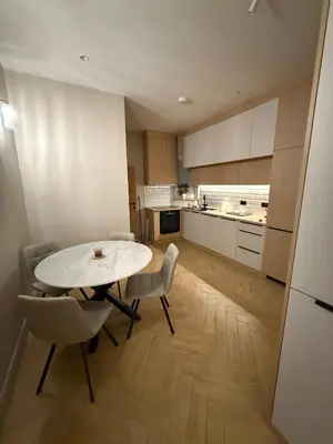 a kitchen with a table and chairs in a room at MiVa Apartment in Belgrade