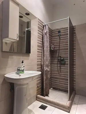 a bathroom with a shower and a sink at TARAS Hostel in Belgrade