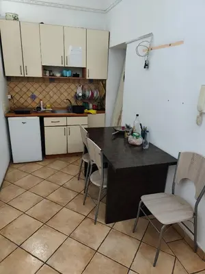 a kitchen with a table and chairs in a room at TARAS Hostel in Belgrade