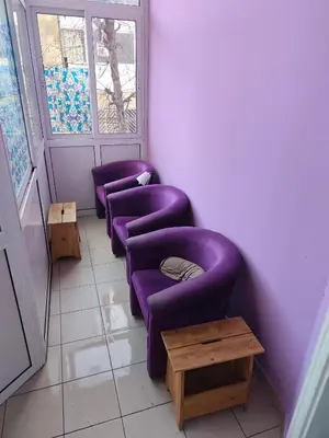 a room with three purple chairs and a table at TARAS Hostel in Belgrade