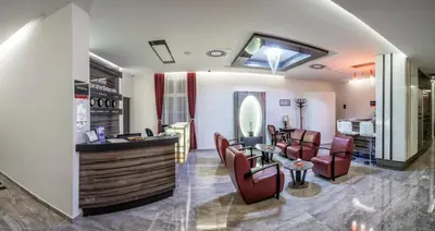 a salon with a waiting room with chairs and a counter at Theater Hotel Belgrade in Belgrade