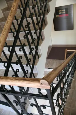 a staircase with wooden and wrought iron railings at Theater Hotel Belgrade in Belgrade