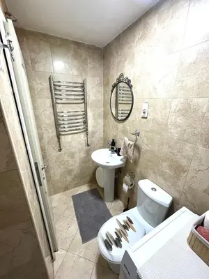 a bathroom with a white toilet and a sink at A&D apartment in Belgrade