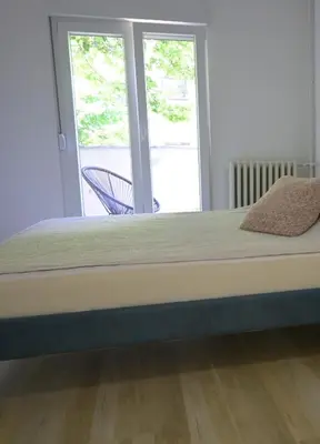 a large bed in a room with a window at Lux Star Apartment in Belgrade
