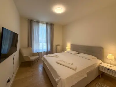 a bedroom with a bed and a tv and a chair at BW City Elegance Collection in Belgrade