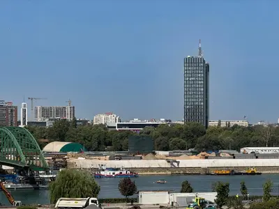 a city skyline with a river and a tall building at BW City Elegance Collection in Belgrade