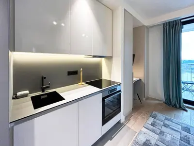 a kitchen with white cabinets and a sink at BW City Elegance Collection in Belgrade