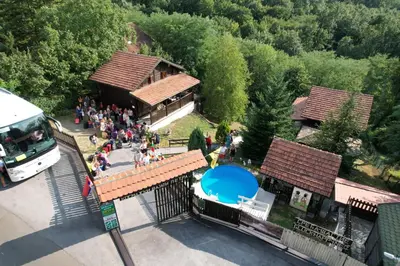 a group of people standing outside of a building at Kosmajski vajati Petra in Nemenikuće