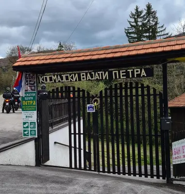 a gate to a building with a sign on it at Kosmajski vajati Petra in Nemenikuće