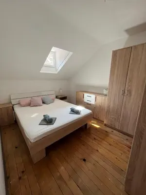a bedroom with a bed with white sheets and a window at Miran Stan u Srcu Grada in Belgrade