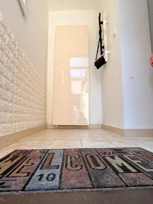 a room with a welcome rug on the floor at Miran Stan u Srcu Grada in Belgrade