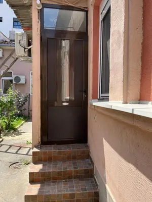 a door on a building with stairs leading to a window at Miran Stan u Srcu Grada in Belgrade
