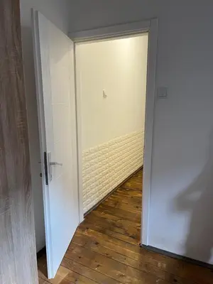 an open door in a room with a wooden floor at Miran Stan u Srcu Grada in Belgrade