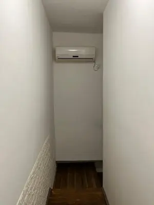 a hallway with a heater in a white wall at Miran Stan u Srcu Grada in Belgrade