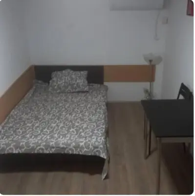 a bedroom with a bed and a dresser and a desk at Julijana in Belgrade