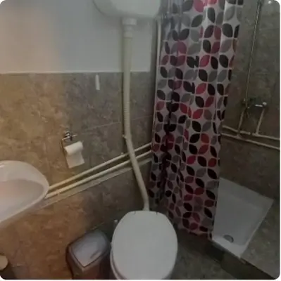 a bathroom with a toilet and a sink and a shower at Julijana in Belgrade