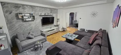 a living room with a couch and a tv at Lux Apartman Stojanović in Belgrade