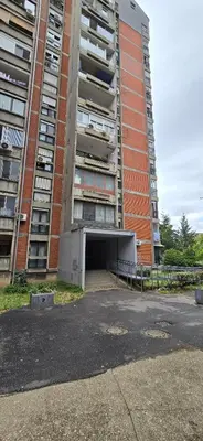 a building with a parking garage in front of it at Lux Apartman Stojanović in Belgrade