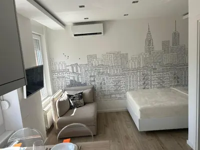 a bedroom with a city mural on the wall at Chic City Studio in Belgrade