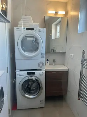 a bathroom with a washing machine and a sink at Chic City Studio in Belgrade