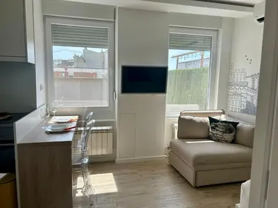 a living room with a couch and a chair at Chic City Studio in Belgrade