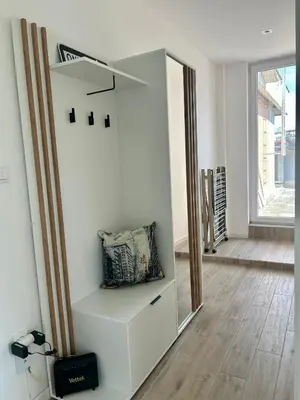 a room with a white cabinet with a pillow on it at Chic City Studio in Belgrade