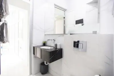 a bathroom with a black sink and a mirror at City center - Mirror apartment in Belgrade