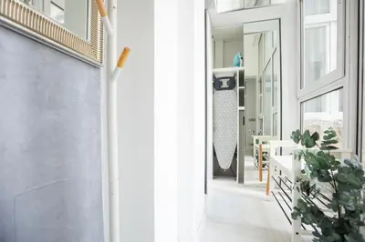 a hallway with a door and a potted plant at City center - Mirror apartment in Belgrade