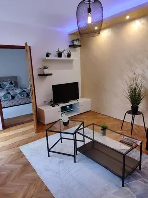 a living room with a tv and a table at Apartman Stay 23 in Smederevo