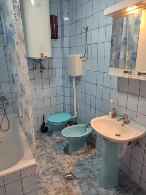 a bathroom with two toilets and a sink at Apartman Stay 23 in Smederevo