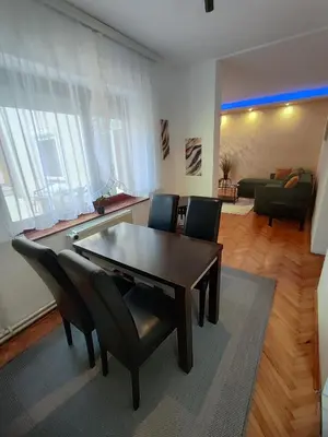 a living room with a dining room table and chairs at Apartman Stay 23 in Smederevo