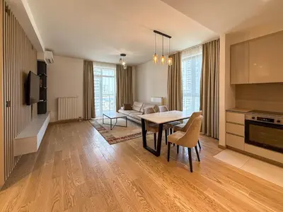 a large living room with a table and a couch at BW Elite Natureline in Belgrade
