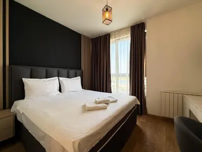 a bedroom with a large bed with a black wall at BW Elite Natureline in Belgrade