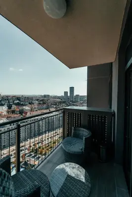 a balcony with chairs and a view of a city at BW Elite Natureline in Belgrade