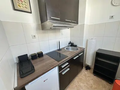 a small kitchen with a sink and a counter at Urban Nest 36A in Belgrade