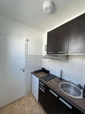 a kitchen with a sink and a white refrigerator at Urban Nest 36A in Belgrade