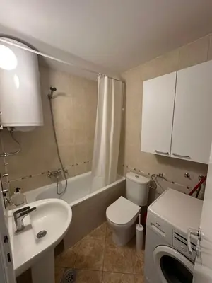 a bathroom with a sink and a toilet and a shower at Urban Nest 36A in Belgrade