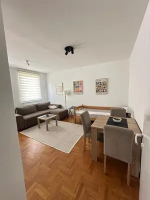 a living room with a table and a couch at Urban Nest 36A in Belgrade