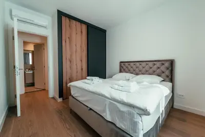 a bedroom with a large bed with white sheets at BW Dolce Residenza in Belgrade