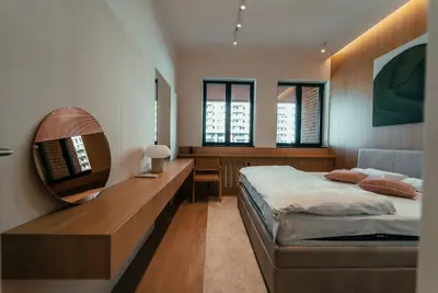 a bedroom with a large bed and a mirror at BW Dolce Residenza in Belgrade