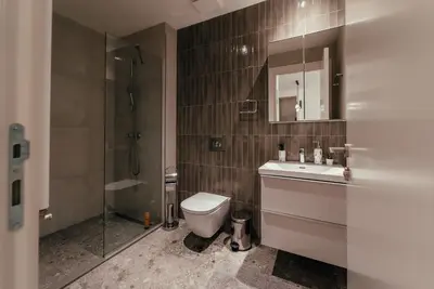 a bathroom with a toilet and a sink and a shower at BW Dolce Residenza in Belgrade
