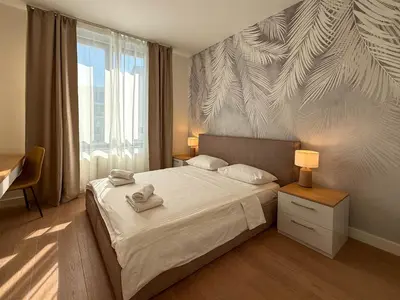 a bedroom with a bed with two towels on it at BW Crown Garden Residences in Belgrade