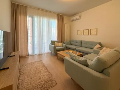a living room with two couches and a table at BW Crown Garden Residences in Belgrade