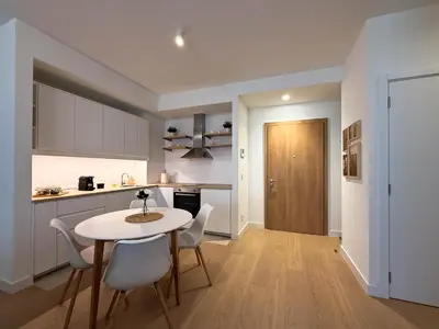 a kitchen and dining room with a table and chairs at BW Crown Garden Residences in Belgrade