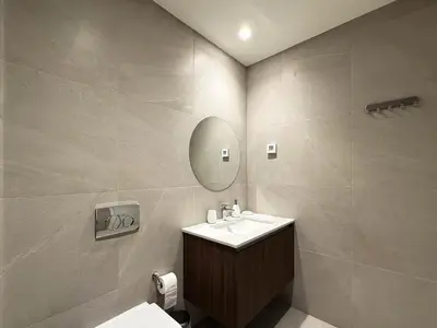 a bathroom with a sink and a mirror at BW Crown Garden Residences in Belgrade