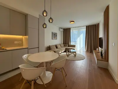 a kitchen and living room with a table and chairs at BW Crown Garden Residences in Belgrade