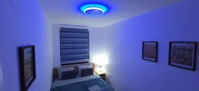a blue room with a bed and a window at Apartman Gora in Irig
